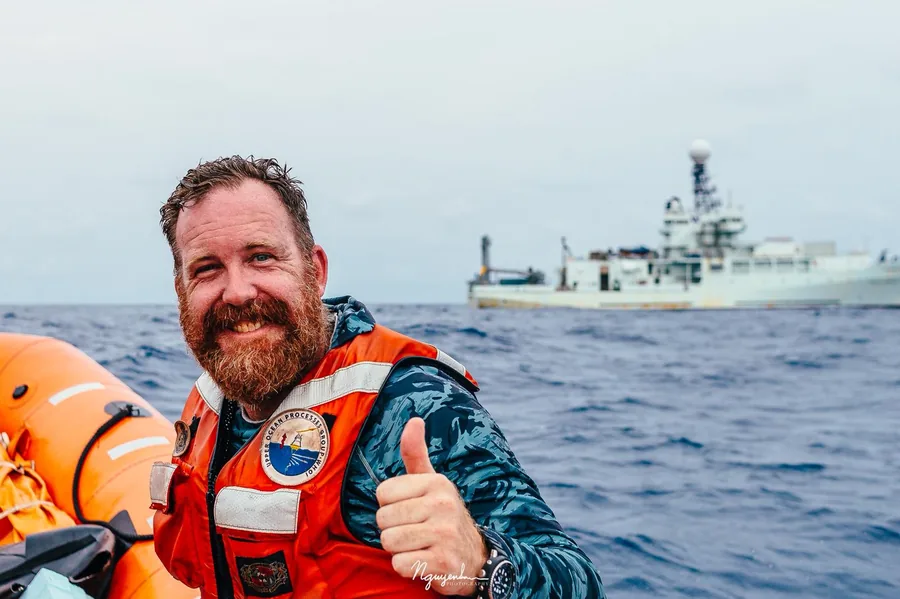 Emerson Hasbrouck on small boat, ASTRAL/EKAMSAT 2024