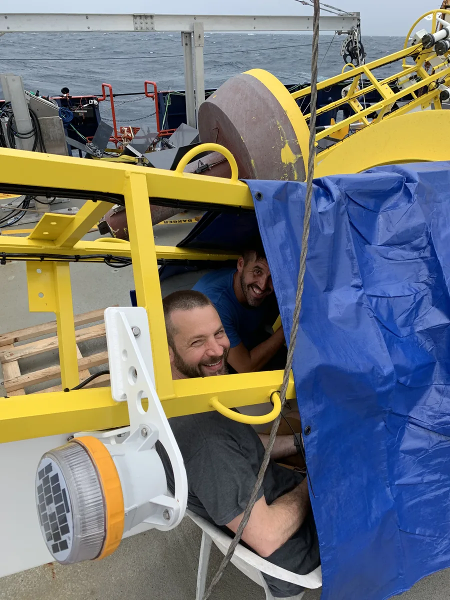 Tom Farrar and Drew Lucas under rain tarp in Chennai, MISO-BoB 2019