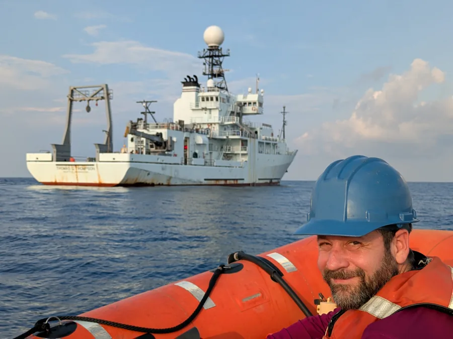 Tom Farrar on small boat with RV Thomas G. Thompson, May 2025